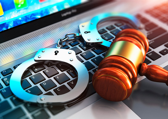 handcuffs and gavel on a keyboard representing a criminal history application