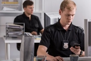 police officer operating mobile in the police station