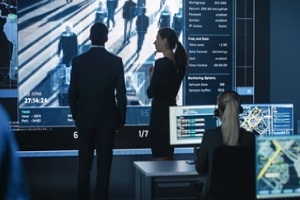 male female officers working on big computer system