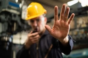 policeman talking on radio and hand stop sign