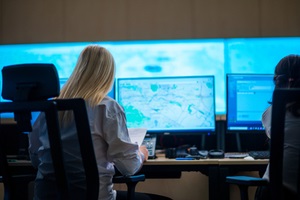 female security guards working in surveillance room