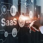 saas software as a service concept with man hand pressing text