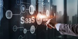 saas software as a service concept with man hand pressing text