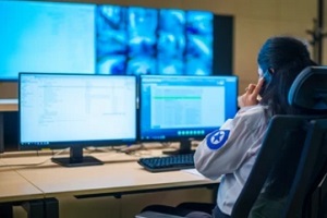 police officer working in two computers