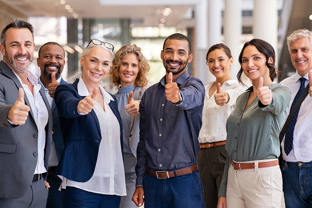 team members taking a happy photo at work