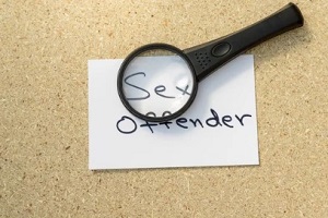 sex offender on white paper with magnifying glass
