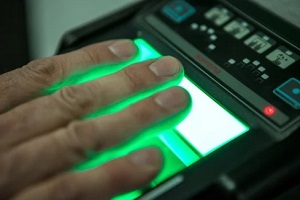man scanning fingerprints on machine